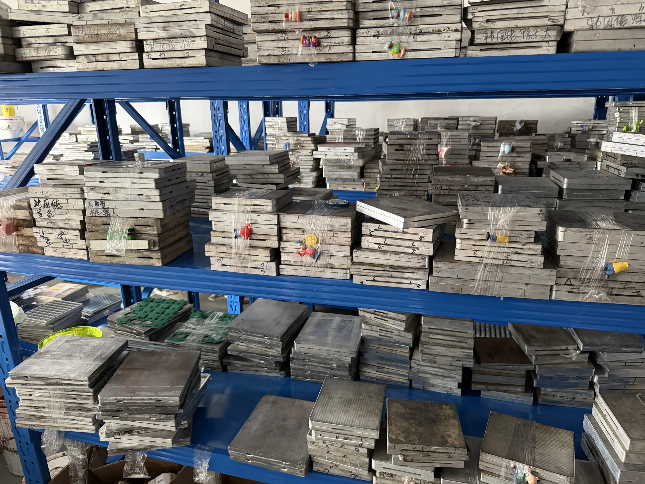 Shelves of steel molds for custom PVC toys