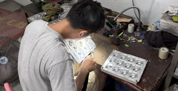 Technician finishing a metal mold for custom PVC toys