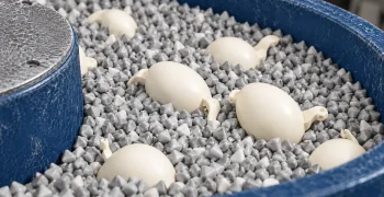 PVC toy parts being tumbled for surface finishing